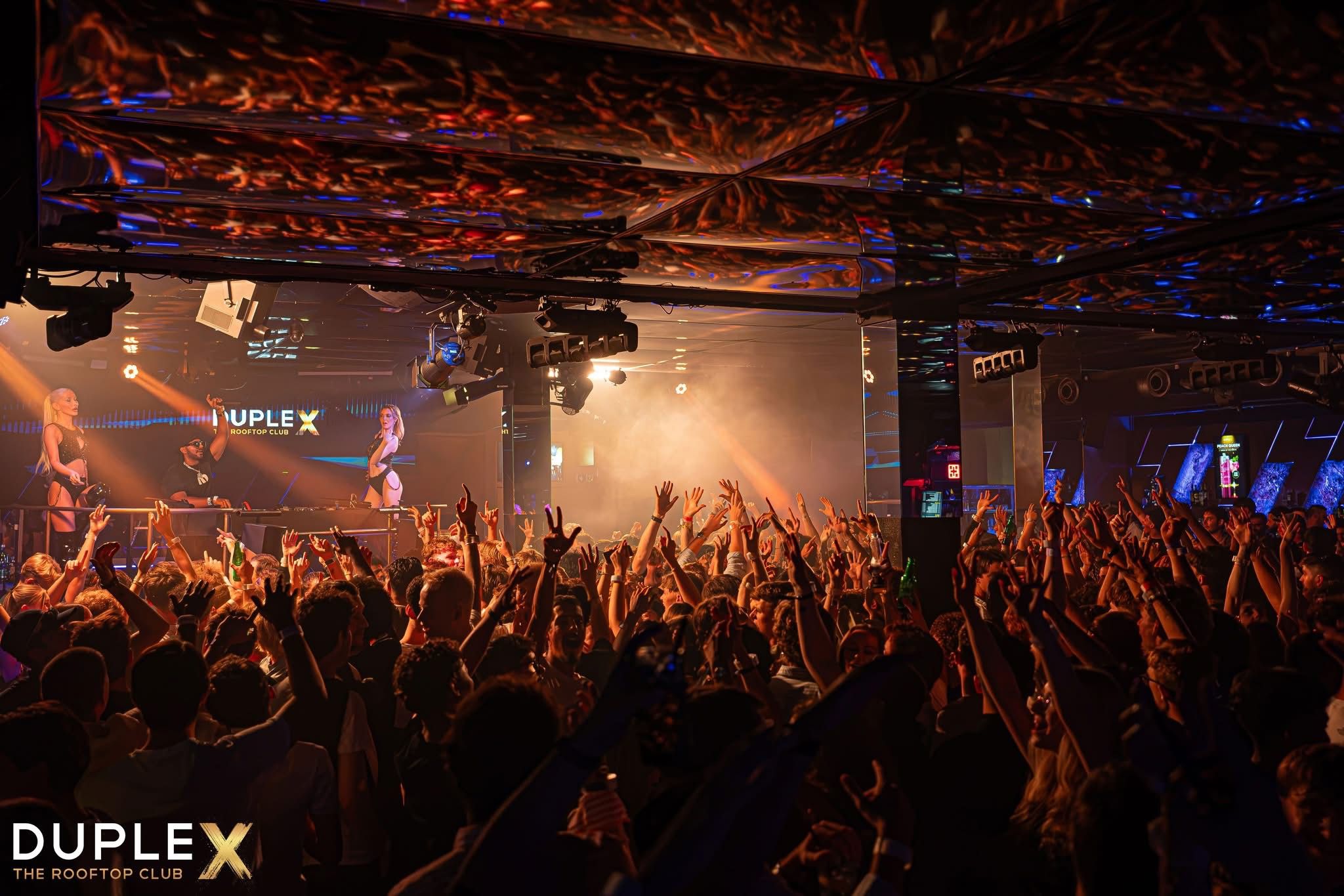 DJ Sheeko performing for a packed crowd at Duplex Rooftop Club