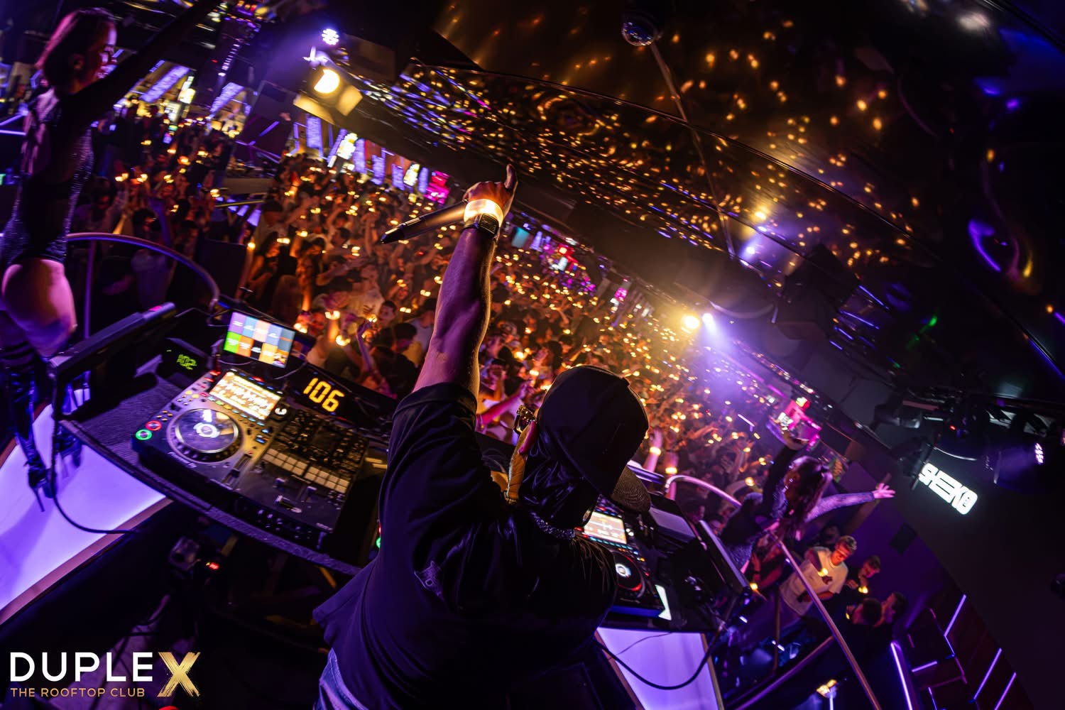 DJ Sheeko performing to an energetic nightclub crowd